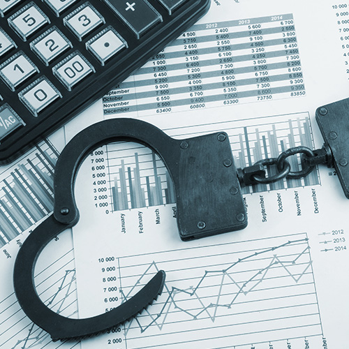 Handcuffs, charts and finance reports and a calculator