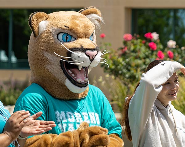 MVC's Monty the Mountain Lion mascot with a student