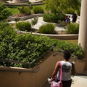 A student walks down the Humanties Building north steps