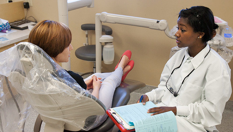 A dental student interviews a patient