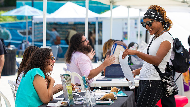 A student talks to a business representative during a tabling event