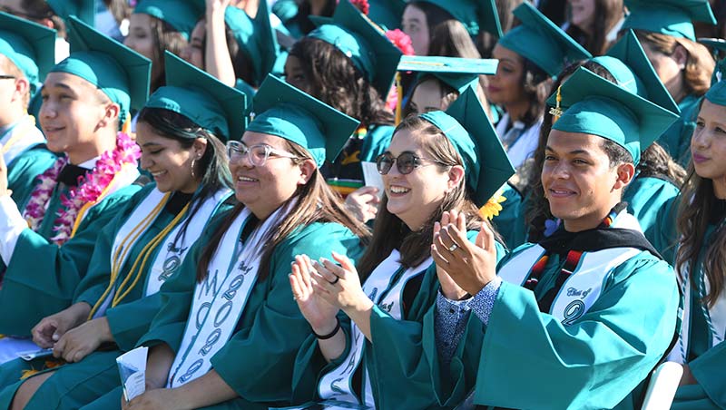 Graduates sit together at Commencement