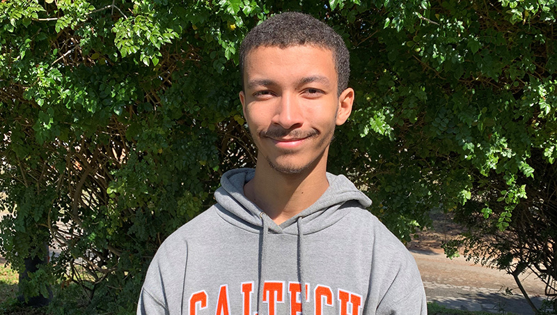 Portrait of Jude McLean wearing a Caltech sweater