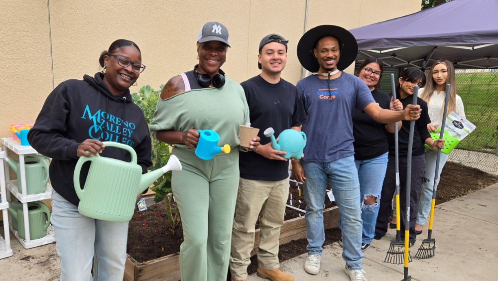 College Corps volunteer students pose for a photo at the garden initiative work day