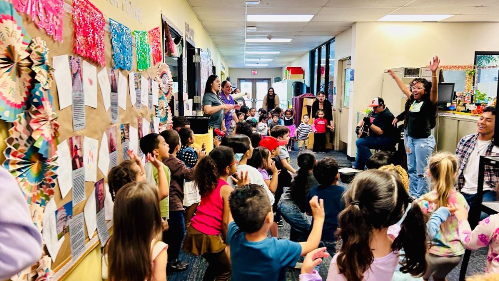 Young children gather in the ECE Center and sing