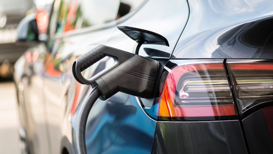 Close-up photograph of an electric car charging from a rear port