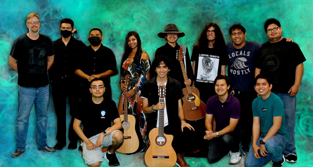 Group photo of the music club with some students holding guitars