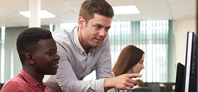 A student is tutored while on the computer