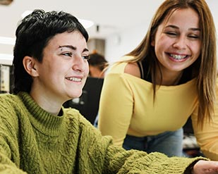 Two students work together to finish an assignment