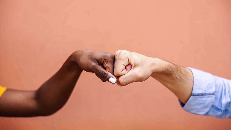 Fist bump between two individuals