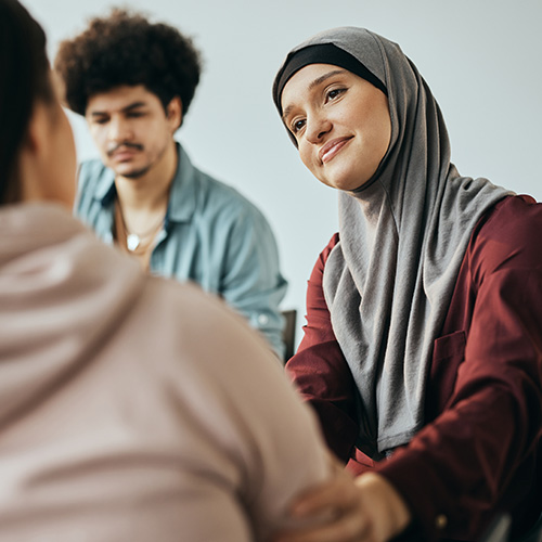 A woman provides support to a group therapy member
