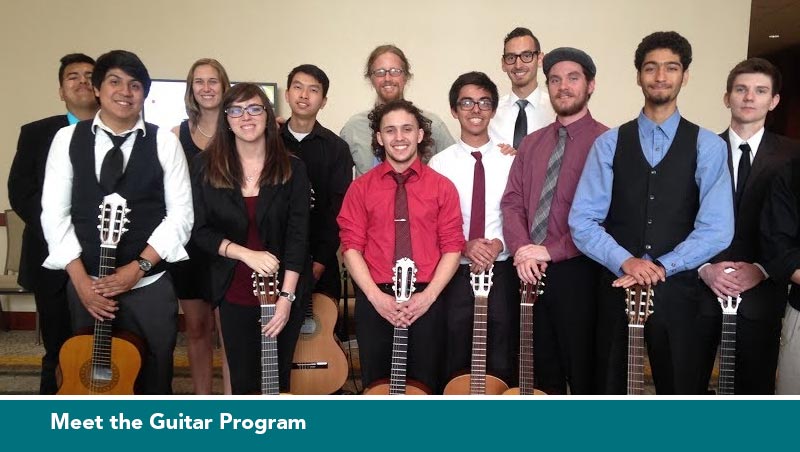 Student guitar performers pose for a photo in a group with their instruments